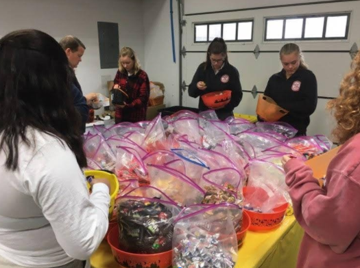 Charity Through Medicine Club members packing candy for Mattie Miracle's Halloween Candy Drive